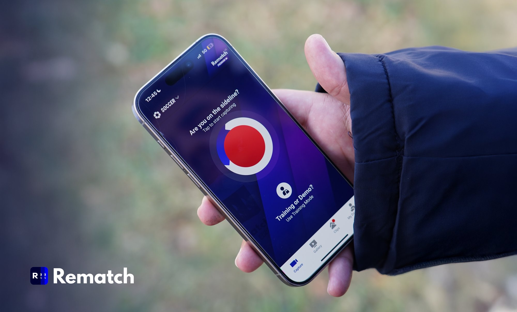 Closeup of hand holding a mobile phone displaying the Rematch app